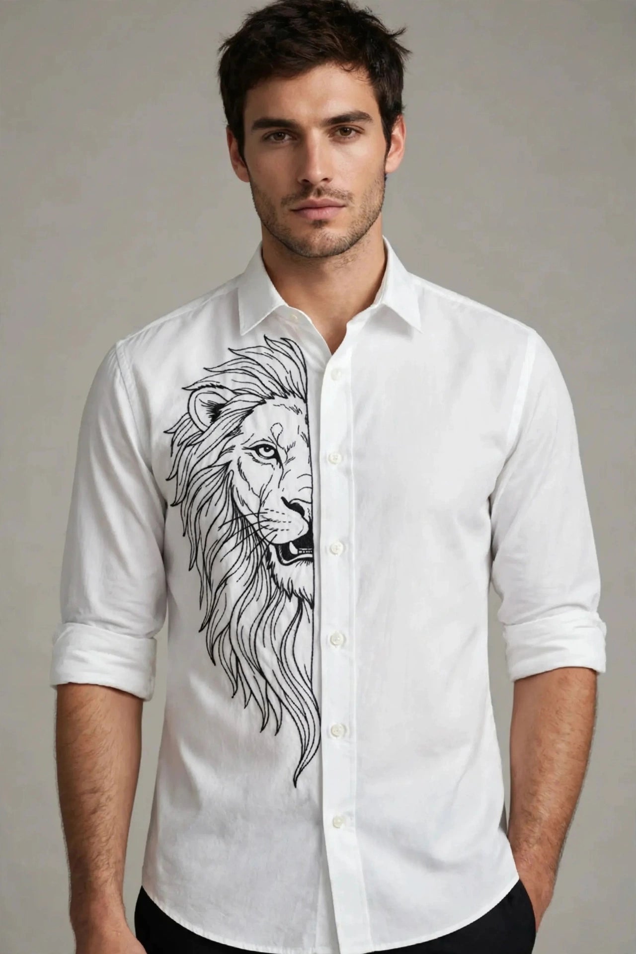 A man wearing a white long-sleeve button-up shirt with a large black line art lion graphic on the front, photographed against a neutral gray studio background.