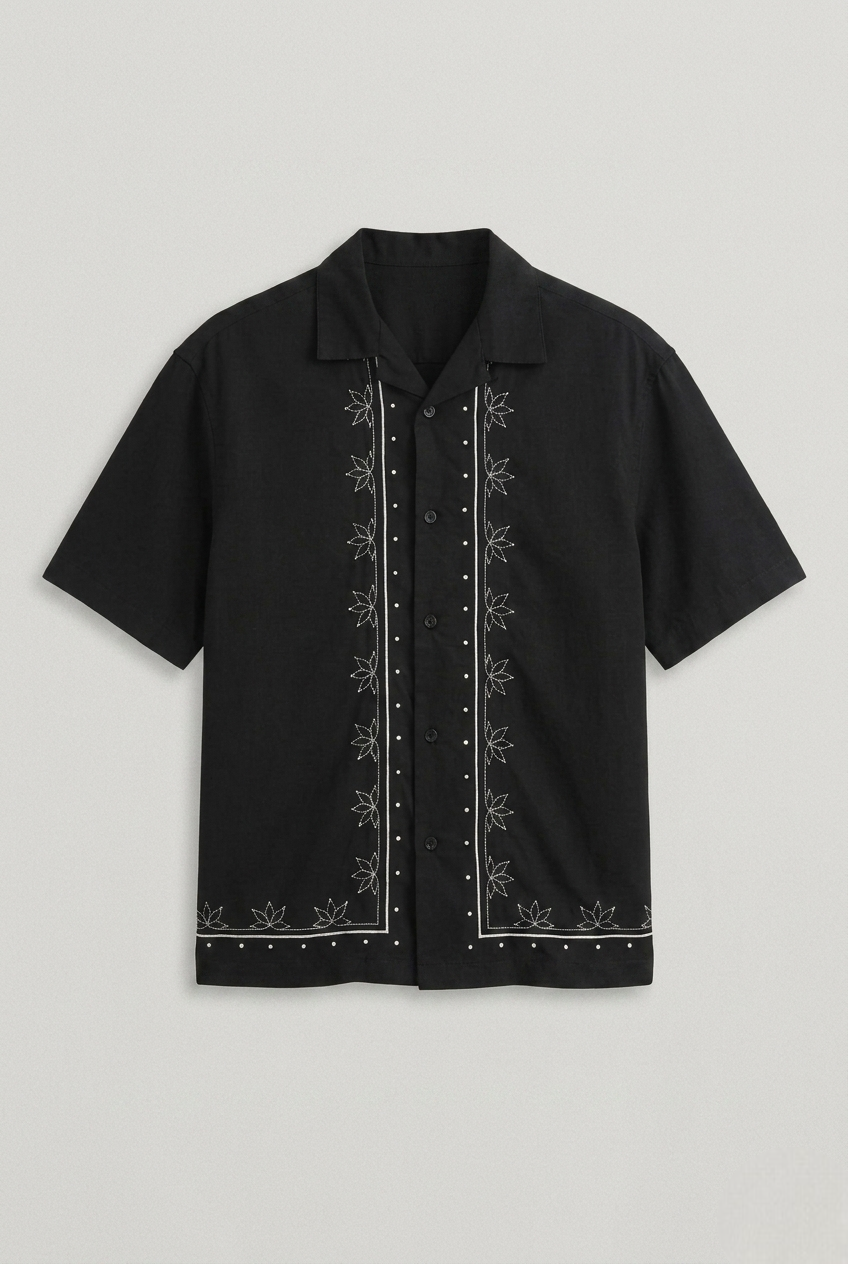 Black short-sleeve shirt with white embroidery on a light gray background